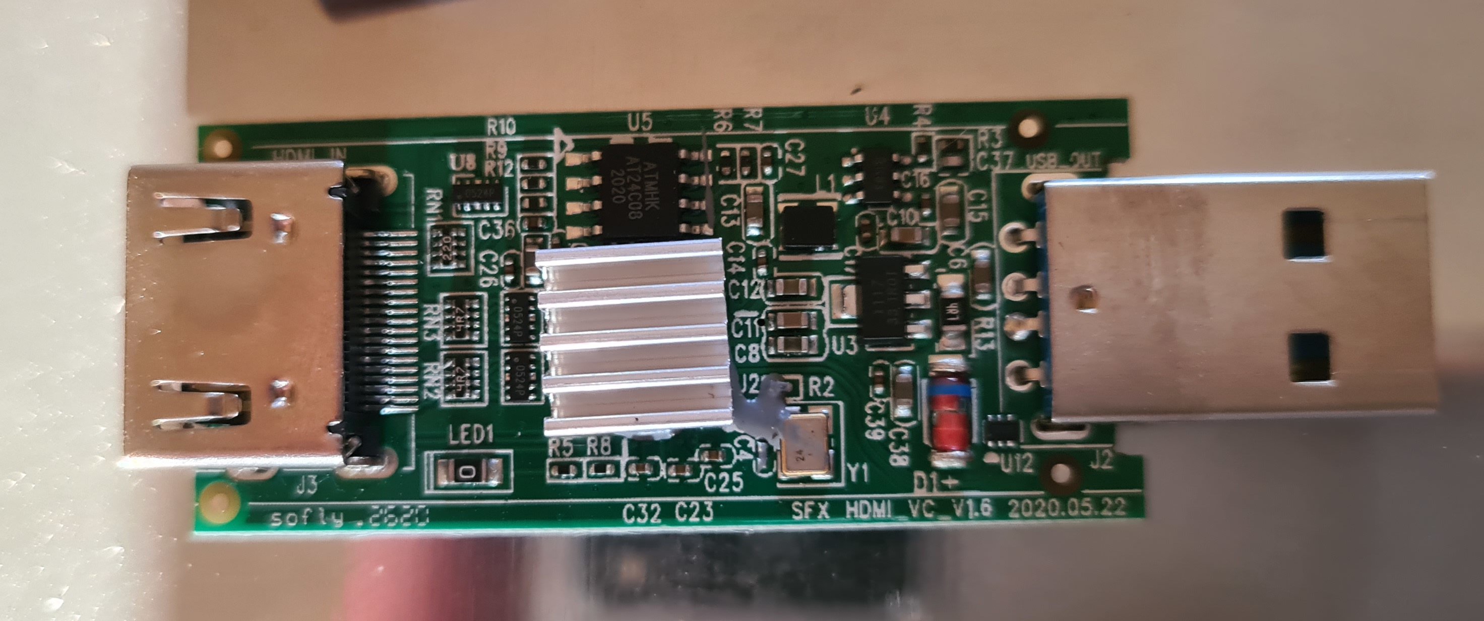 The PCB of the dongle. It has the marking "SFX_HDMI_VC_1.6" and a large heat-sinked chip.